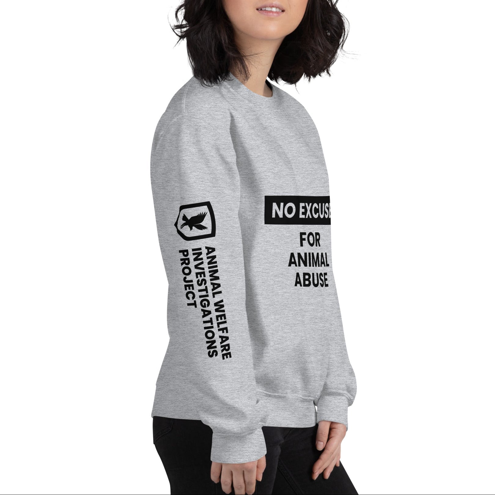 Person wearing a gray sweatshirt with text and logo on a white background